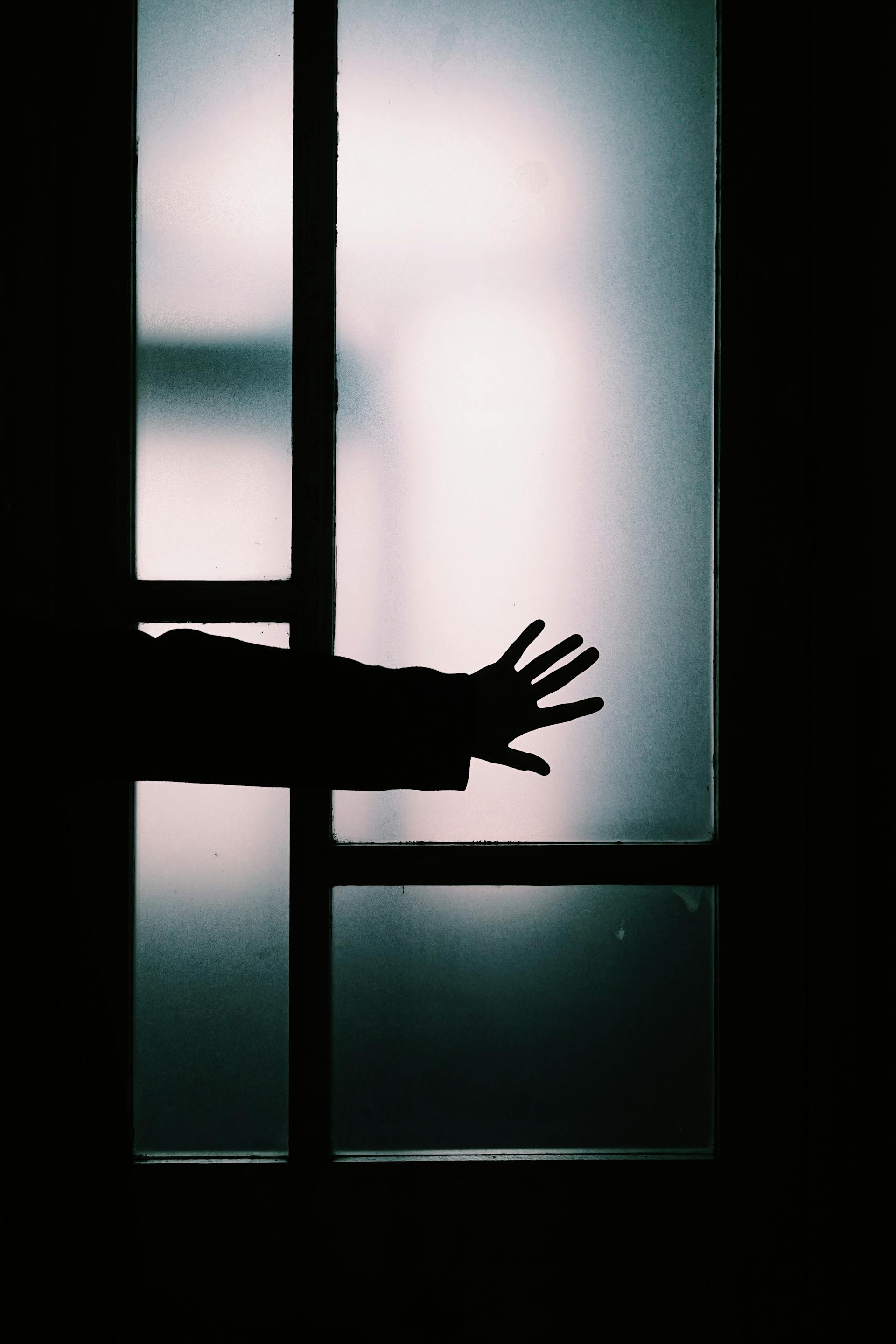 hand behind glass 
